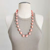 CORAL COLORED SKULL BEAD NECKLACE-28"