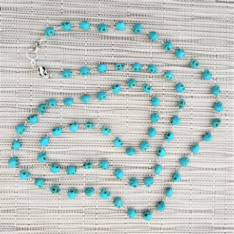 TURQUOISE COLORED SKULL BEAD NECKLACE-42 INCHES