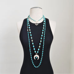 TURQUOISE COLORED SKULL BEAD NECKLACE-42 INCHES