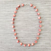 CORAL COLORED SKULL BEAD NECKLACE-28"